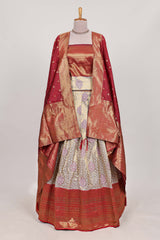 Red tissue lehenga featuring intricate thread weaving details with a beautiful contrast border Paired with a brocadeshawl
