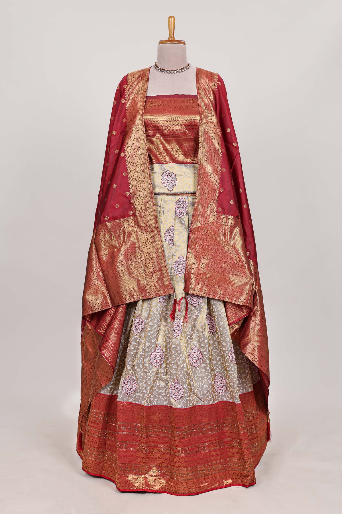 Red tissue lehenga featuring intricate thread weaving details with a beautiful contrast border Paired with a brocade  shawl