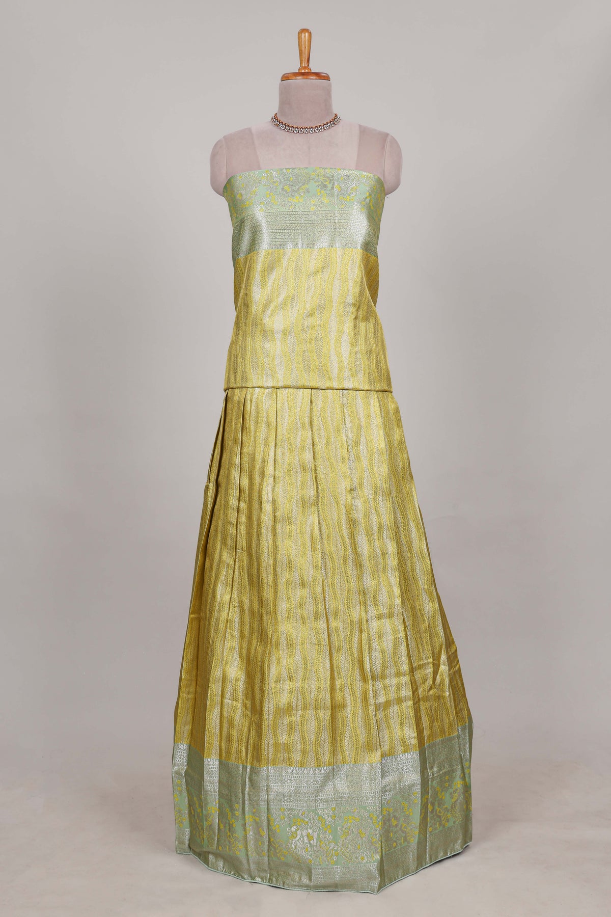 Lemon yellow tissue lehenga featuring elegant vertical line patterns with a beautiful contrast border Paired with a matching shawl