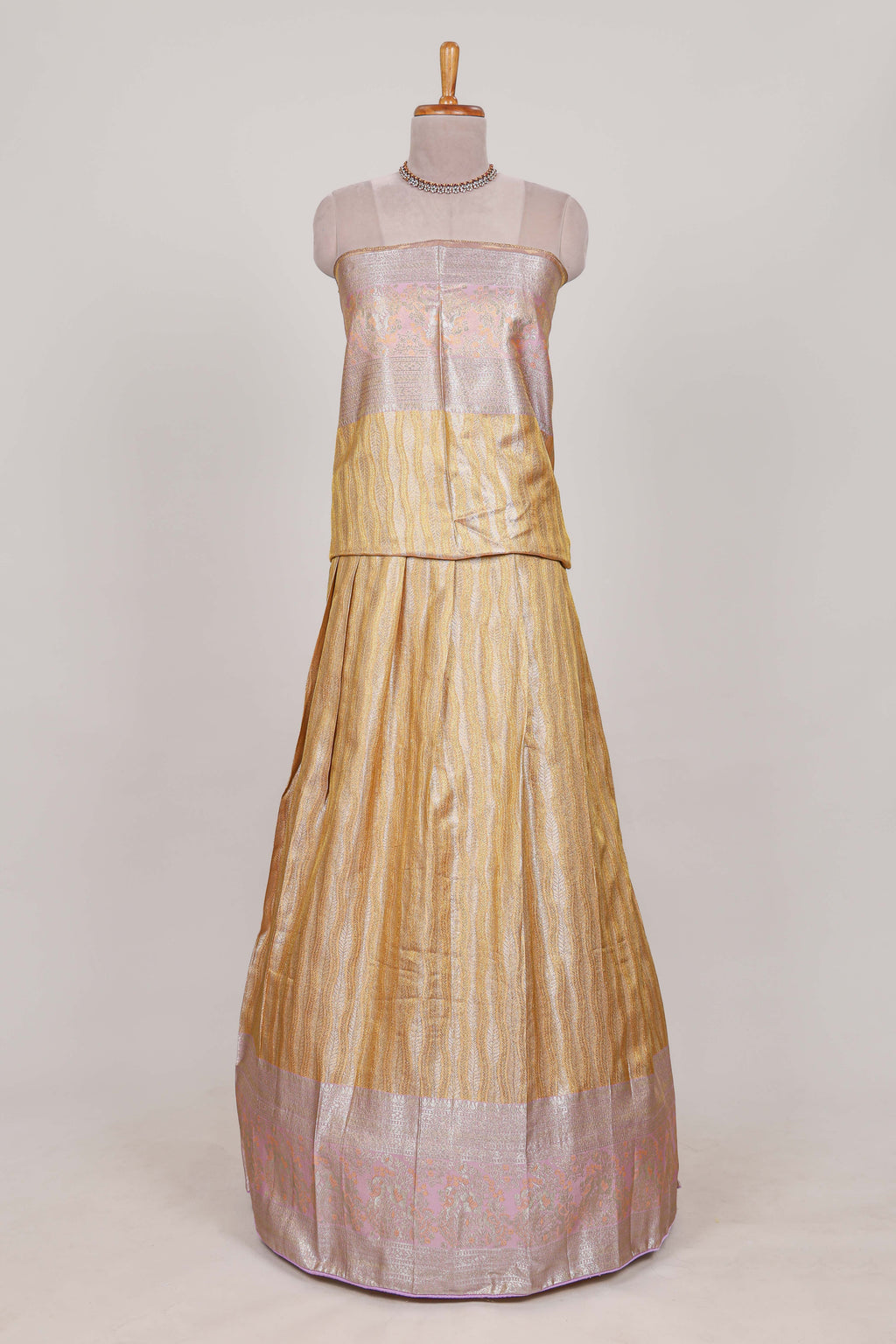Cream tissue lehenga featuring elegant vertical line patterns with a beautiful contrast border Paired with a matching shawl