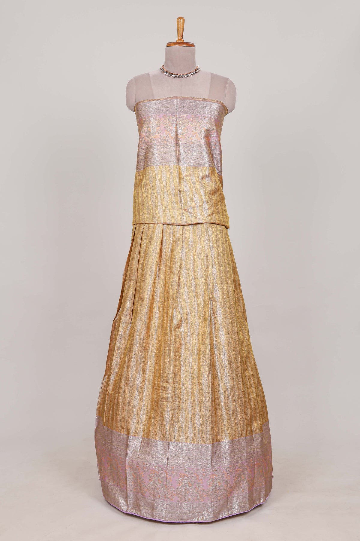 Cream tissue lehenga featuring elegant vertical line patterns with a beautiful contrast border Paired with a matching shawl