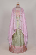 Pastel green tissue lehenga featuring elegant vertical line patterns with a beautiful contrast border Paired with a matching shawl