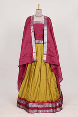 Mustard yellow silk cotton lehenga with a rich maroon shawl with a traditional silver zari woven border and contrast blouse