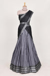 Grey silk cotton lehenga with a black shawl with a traditional silver zari woven border and contrast blouse