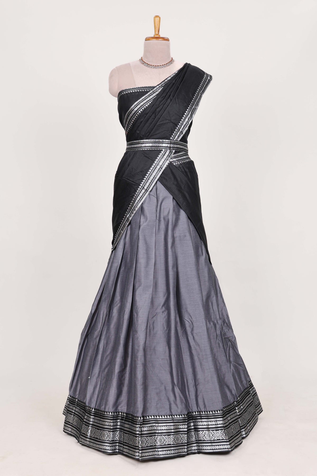Grey silk cotton lehenga with a black shawl with a traditional silver zari woven border and contrast blouse