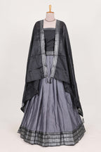 Grey silk cotton lehenga with a black shawl with a traditional silver zari woven border and contrast blouse