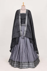 Grey silk cotton lehenga with a black shawl with a traditional silver zari woven border and contrast blouse