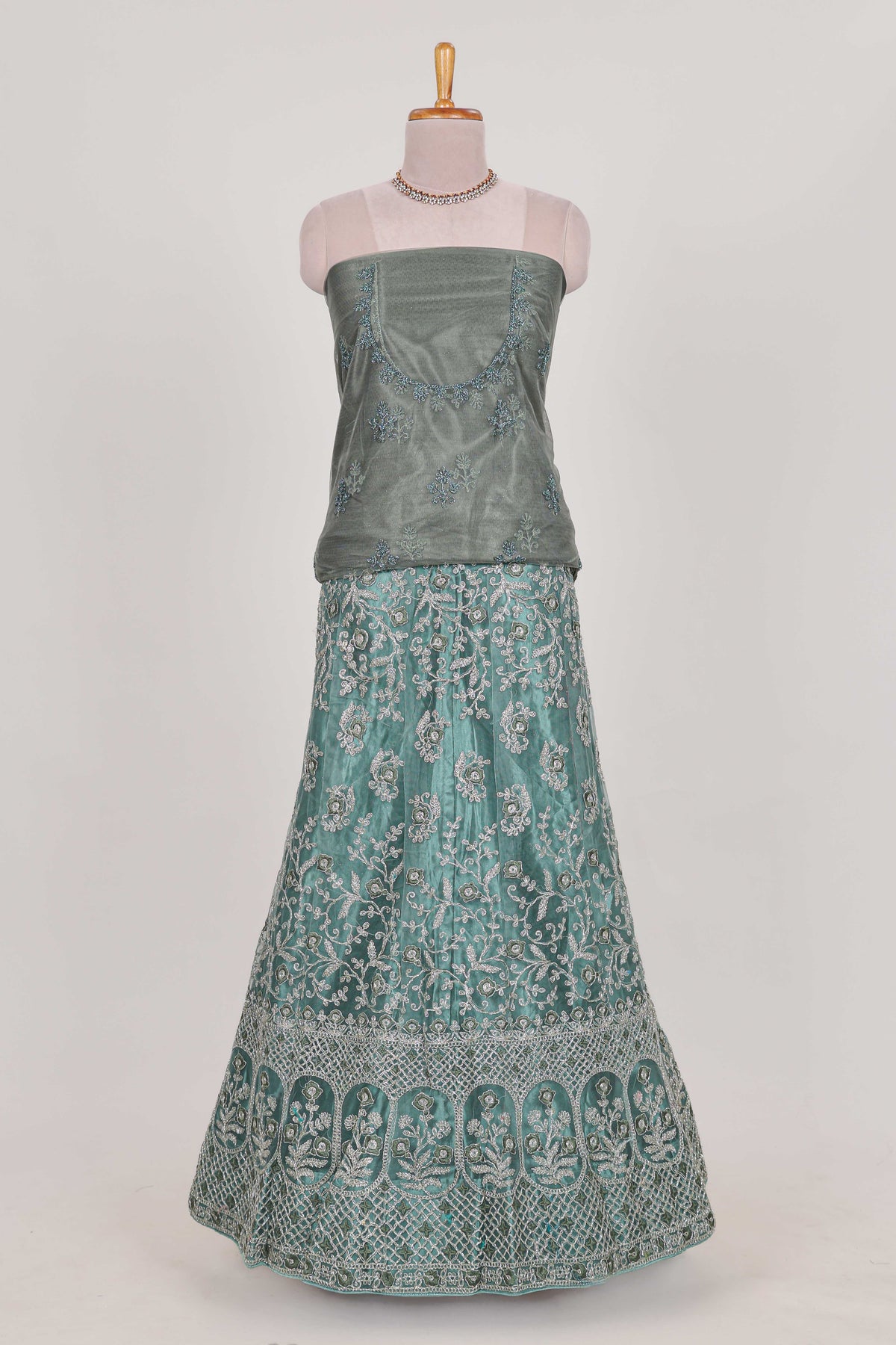 Pastel Sage Green Beautiful net lehenga with intricate embroidery stone work and contrast border paired with a contrast net shawl