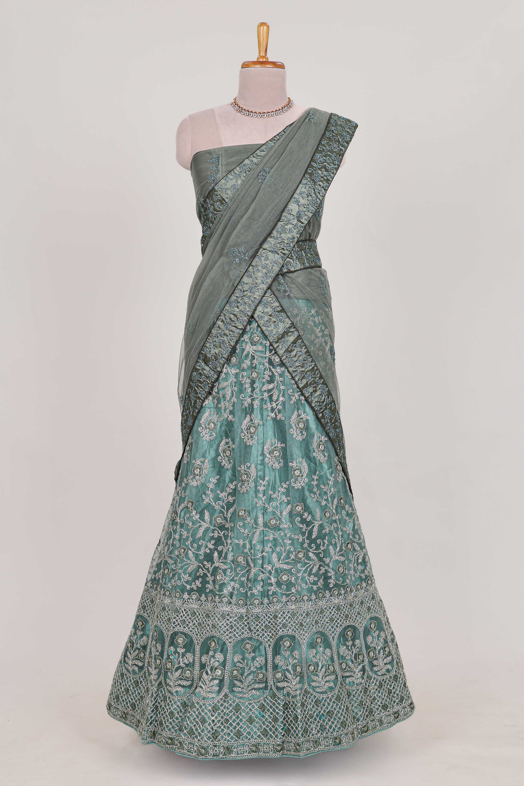 Pastel Sage Green Beautiful net lehenga with intricate embroidery stone work and contrast border paired with a contrast net shawl