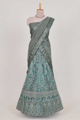 Pastel Sage Green Beautiful net lehenga with intricate embroidery stone work and contrast border paired with a contrast net shawl