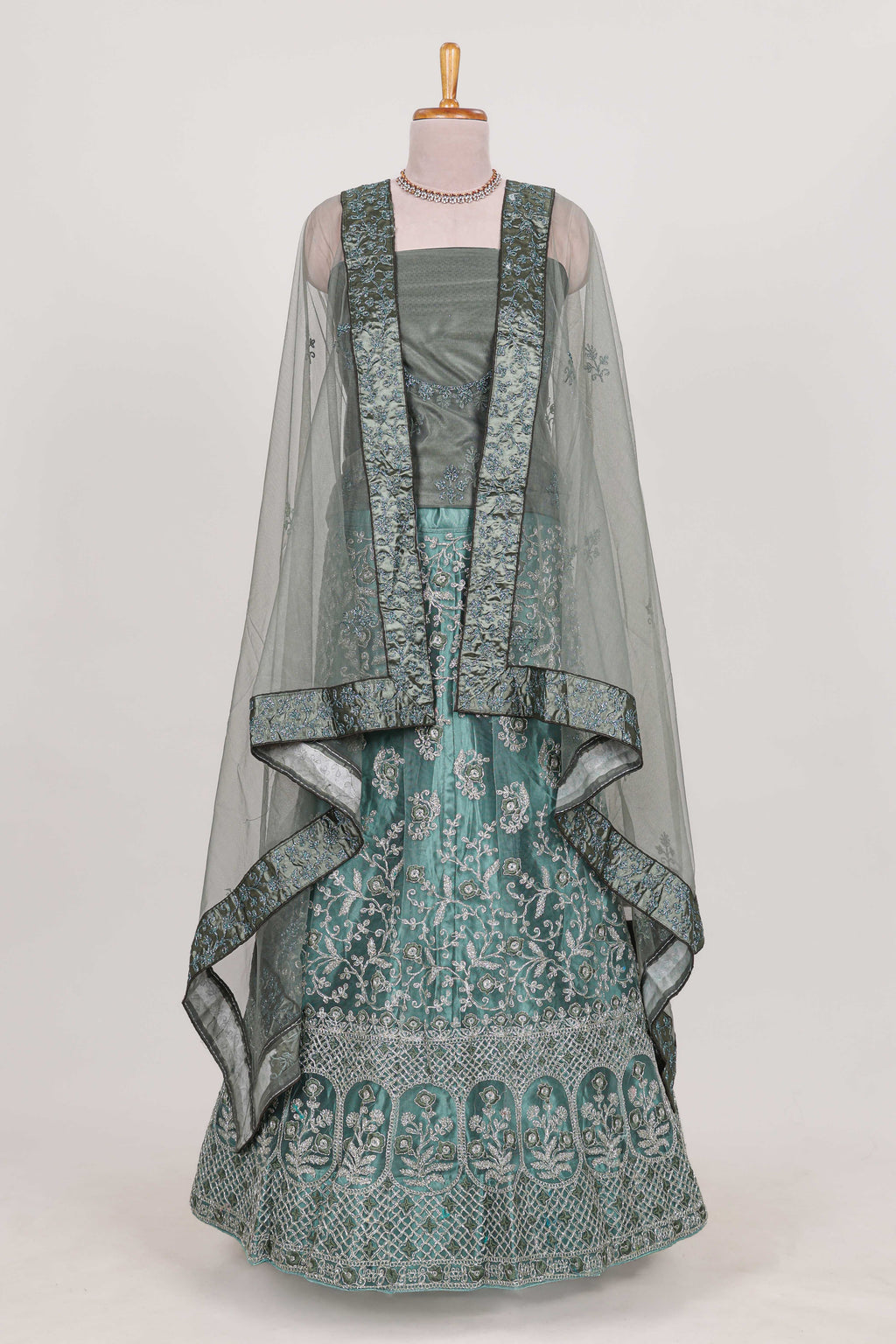 Pastel Sage Green Beautiful net lehenga with intricate embroidery stone work and contrast border paired with a contrast net shawl