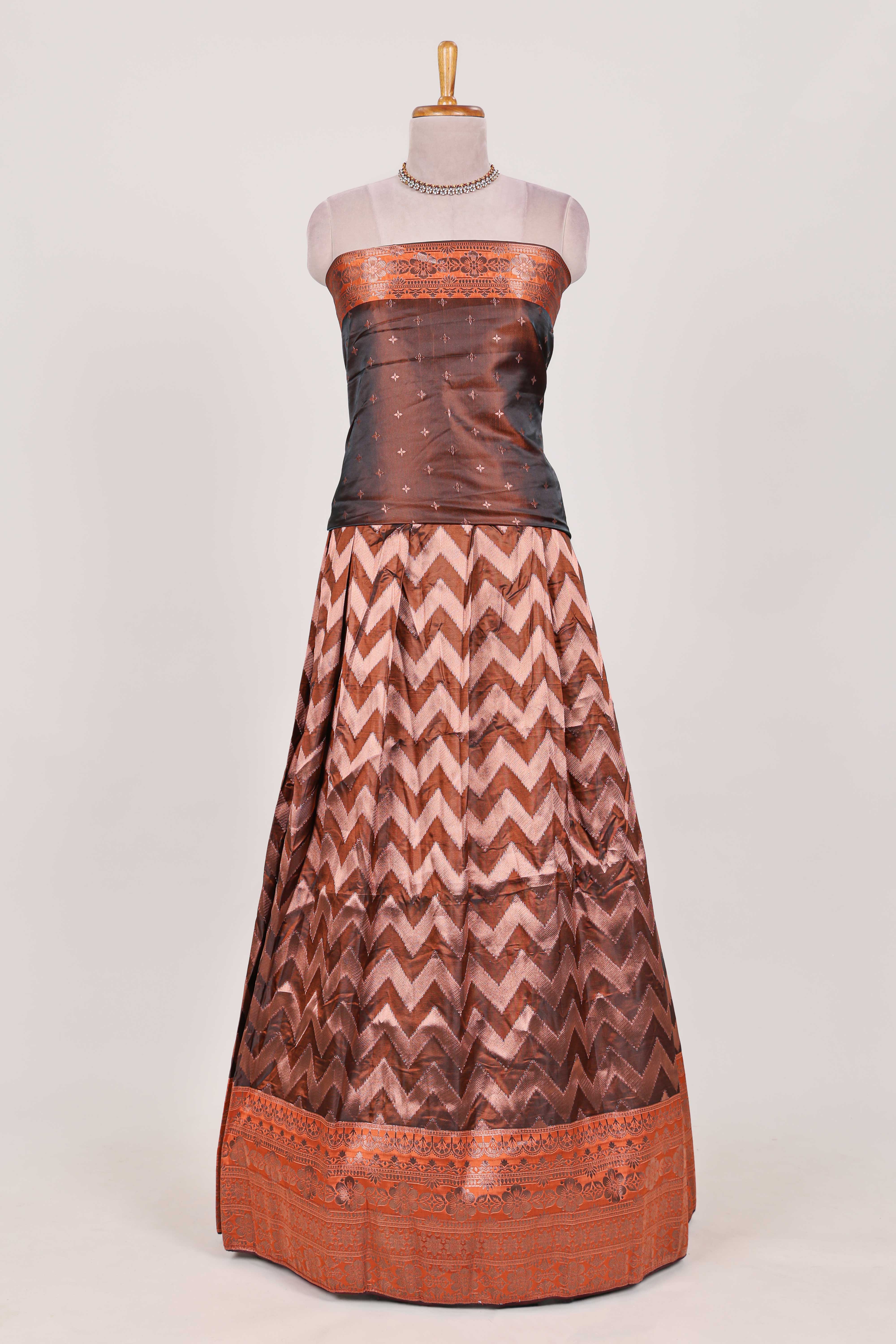 Brown lehenga featuring intricate copper thread weaving details with a beautiful contrast border Paired with a brocadeshawl