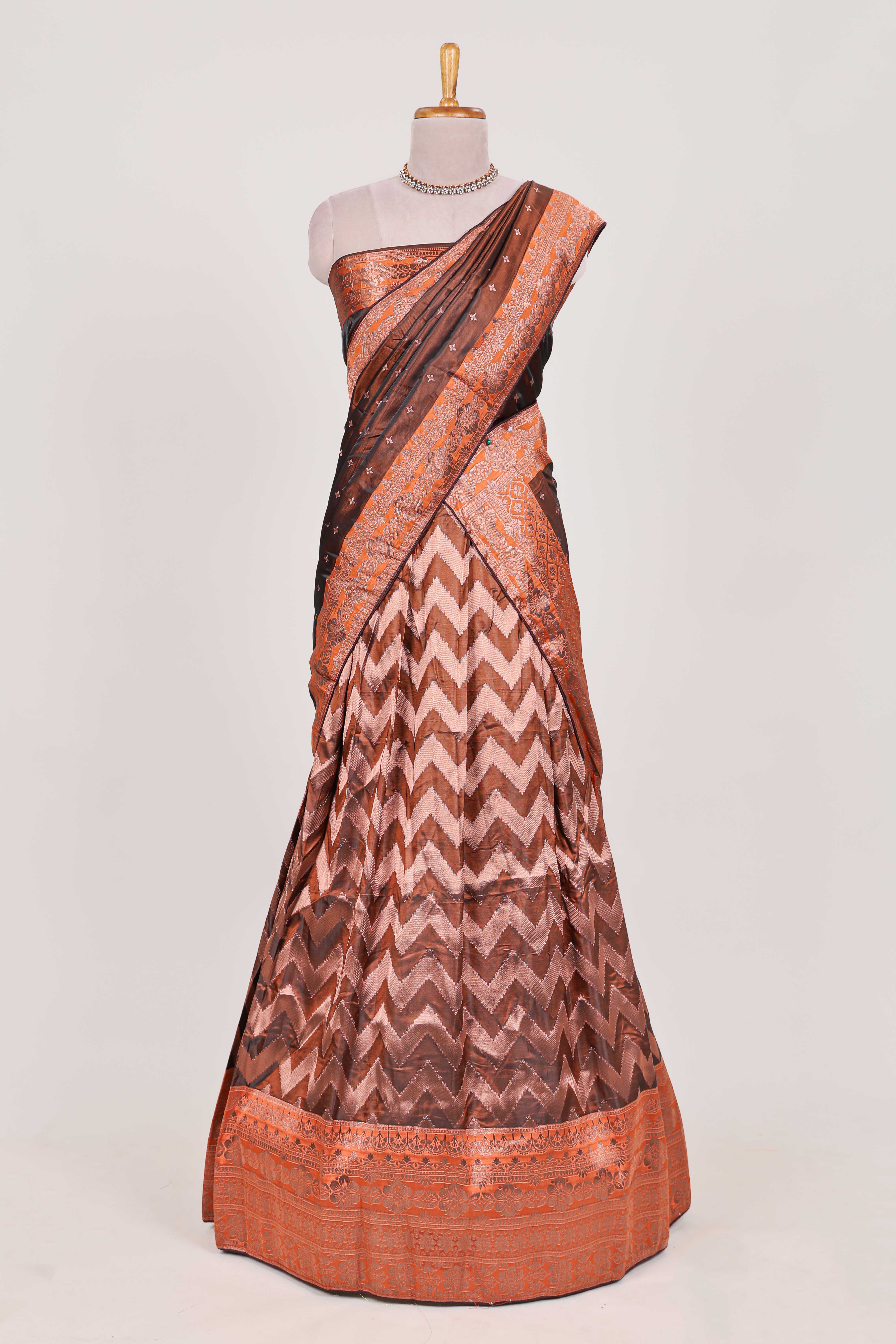 Brown lehenga featuring intricate copper thread weaving details with a beautiful contrast border Paired with a brocadeshawl