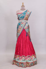 Rani pink plain lehenga featuring with human figure motifs with floral and ornamental detailing border Paired with a teal blue floral designedshawl