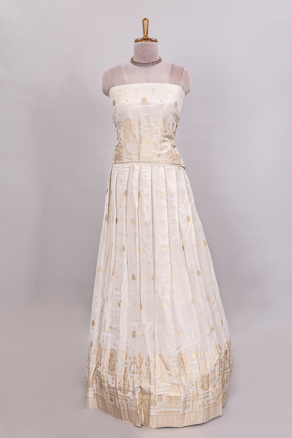 Ivory floral butta motif deigns lehenga featuring self golden zari border and matching blouse Paired with navy blue Floral butta shawl
