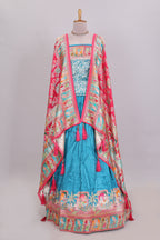 Blue plain lehenga featuring with human figure motifs with floral and ornamental detailing border Paired with a pink floral designed  shawl