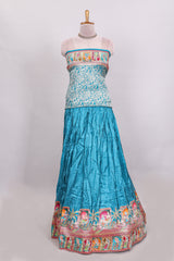 Blue plain lehenga featuring with human figure motifs with floral and ornamental detailing border Paired with a pink floral designedshawl