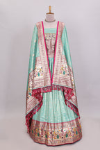 Pista green butta designed lehanga with contrast floral design border and contrast blouse paired with matching floral butta motifs shawl