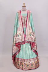 Pista green butta designed lehanga with contrast floral design border and contrast blouse paired with matching floral butta motifs shawl