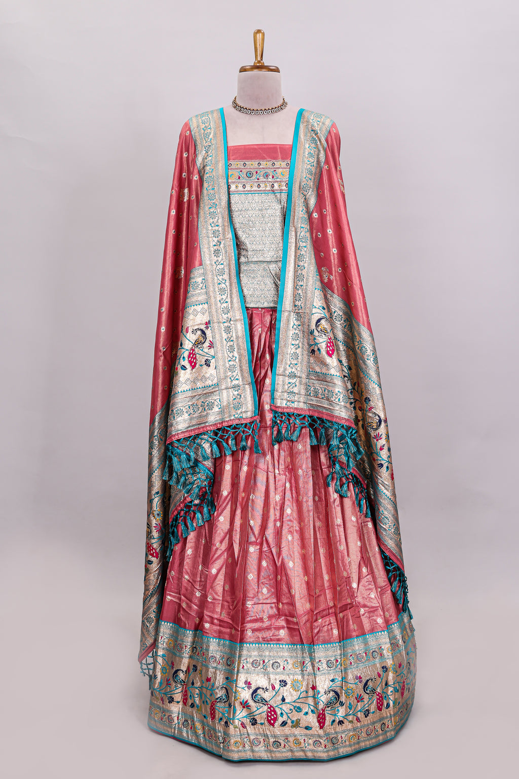 Peach butta designed lehanga with contrast floral design border and contrast blouse paired with matching floral butta motifs shawl