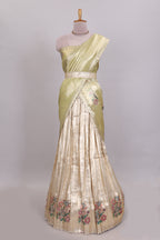 Gold shade zari designed lehanga with self floral motifs border and light green shade contrast blouse paired with plain shawl with few floral motifs