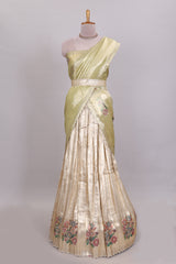 Gold shade zari designed lehanga with self floral motifs border and light green shade contrast blouse paired with plain shawl with few floral motifs