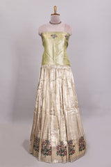 Gold shade zari designed lehanga with self floral motifs border and light green shade contrast blouse paired with plain shawl with few floral motifs