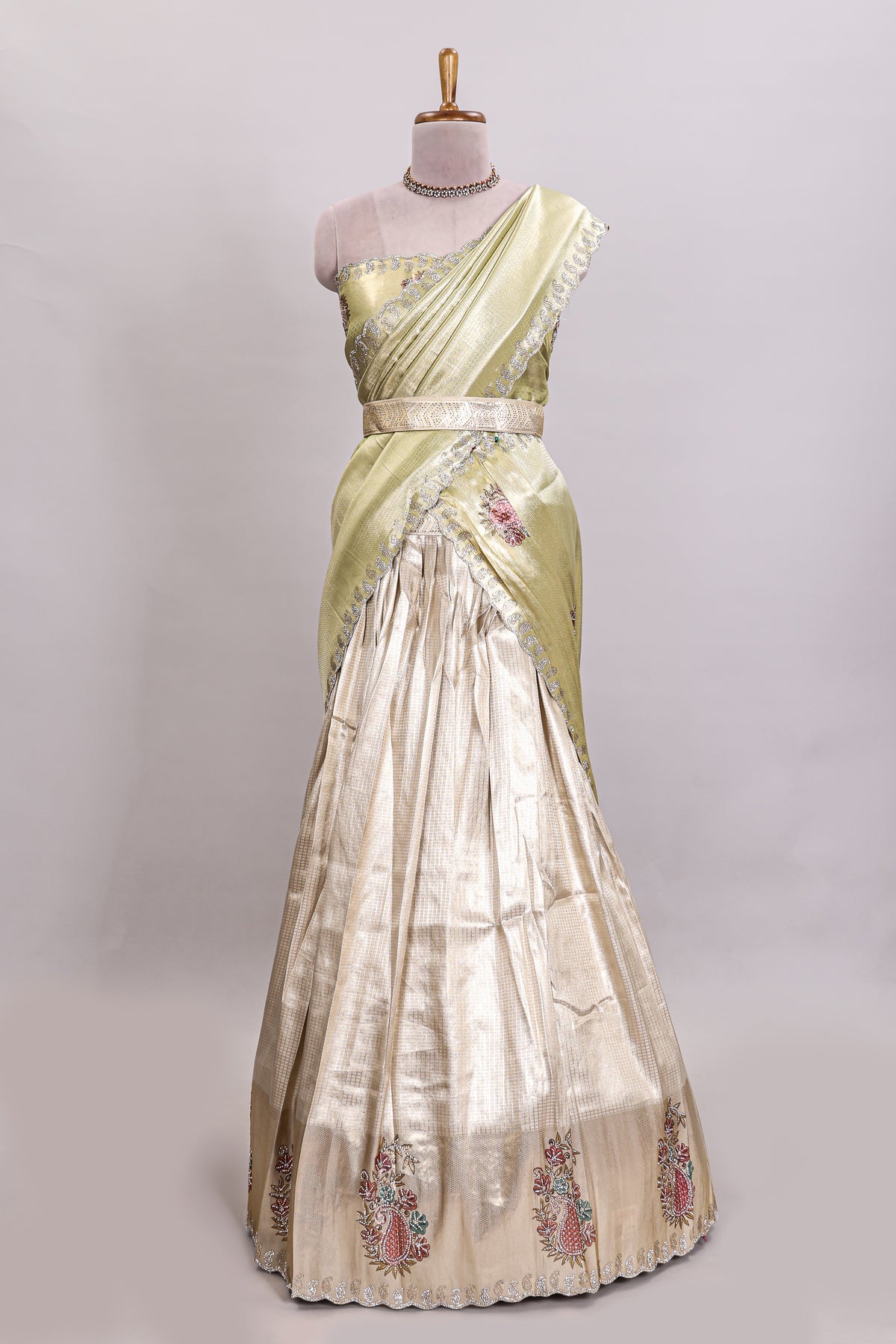Gold shade lehanga with self manga motif border and light green shade contrast blouse paired with plain shawl with floral motifs