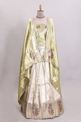 Gold shade lehanga with self manga motif border and light green shade contrast blouse paired with plain shawl with floral motifs