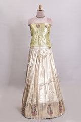 Gold shade lehanga with self manga motif border and light green shade contrast blouse paired with plain shawl with floral motifs