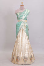 Off white tissue lehenga featuring intricate woven floral paisley motifs with a beautiful zari border Paired with a seafoam green shawl