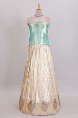 Off white tissue lehenga featuring intricate woven floral paisley motifs with a beautiful zari border Paired with a seafoam green shawl