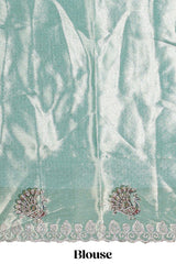 Off white plain lehanga featuring self floral butta design border and contrast teal green blouse beautifully embellished with a stone-work border paired with matching shawl