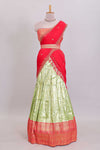 Pastel green Manga Butta motifs lehanga featuring contrasting border and matching blouse paired with contrast red shawl