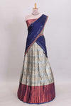 Antique ivory unique designed lehanga featuring contrasting border and matching blouse paired with contrast navy blue shawl