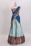 Light aqua blue floral and deer motifs lehanga featuring contrasting geometric zari border and matching blouse paired with contrast blue shawl