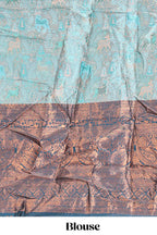 Light aqua blue floral and deer motifs lehanga featuring contrasting geometric zari border and matching blouse paired with contrast blue shawl