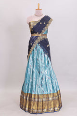 Light blue shade manga motifs lehanga featuring contrasting zari border and matching blouse paired withnavy blue organza shawl