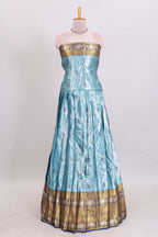 Light blue shade manga motifs lehanga featuring contrasting zari border and matching blouse paired with  navy blue organza shawl