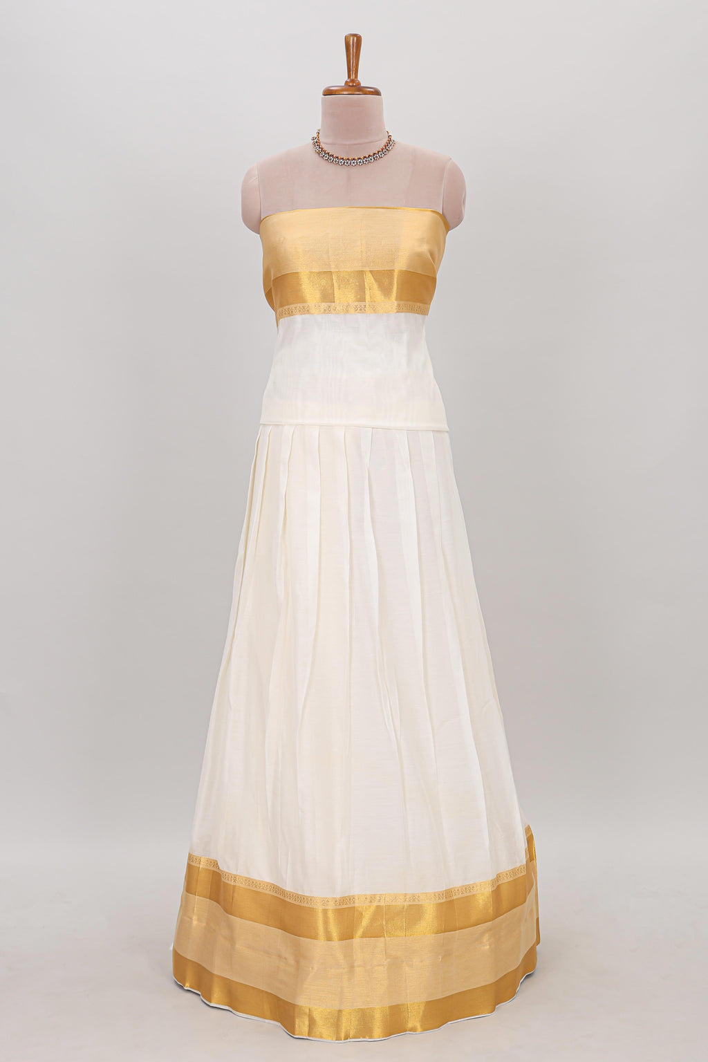 White plain lehanga featuring matching blouse paired with green stone work dhavani