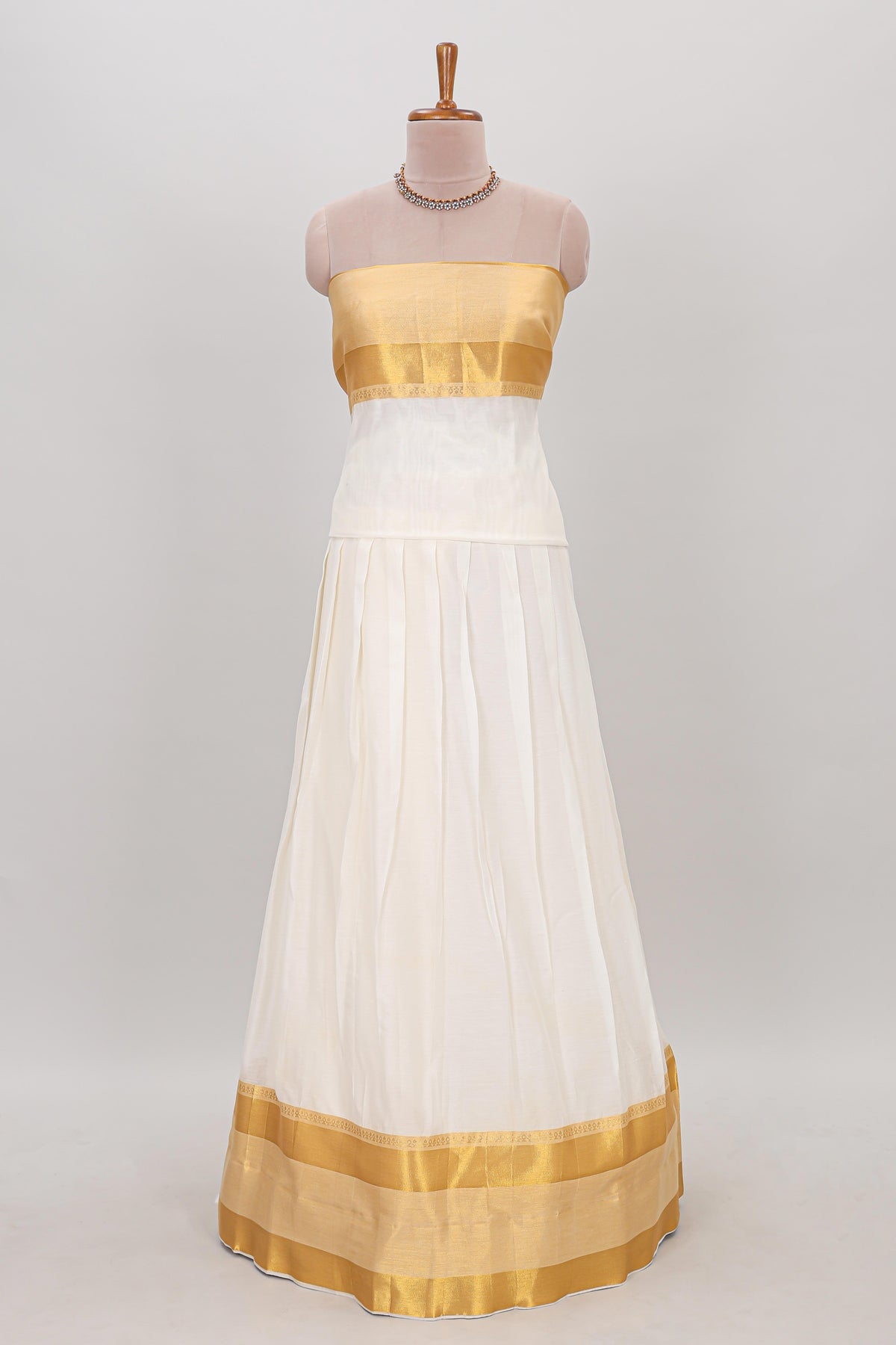 White plain lehanga featuring matching blouse paired with green stone work dhavani