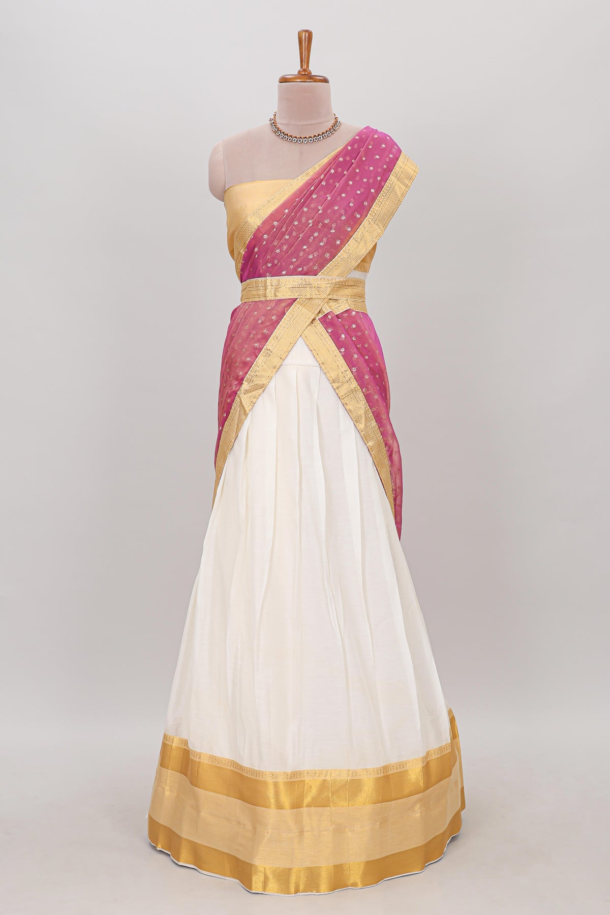 White plain lehanga featuring matching blouse paired with pink stone work dhavani