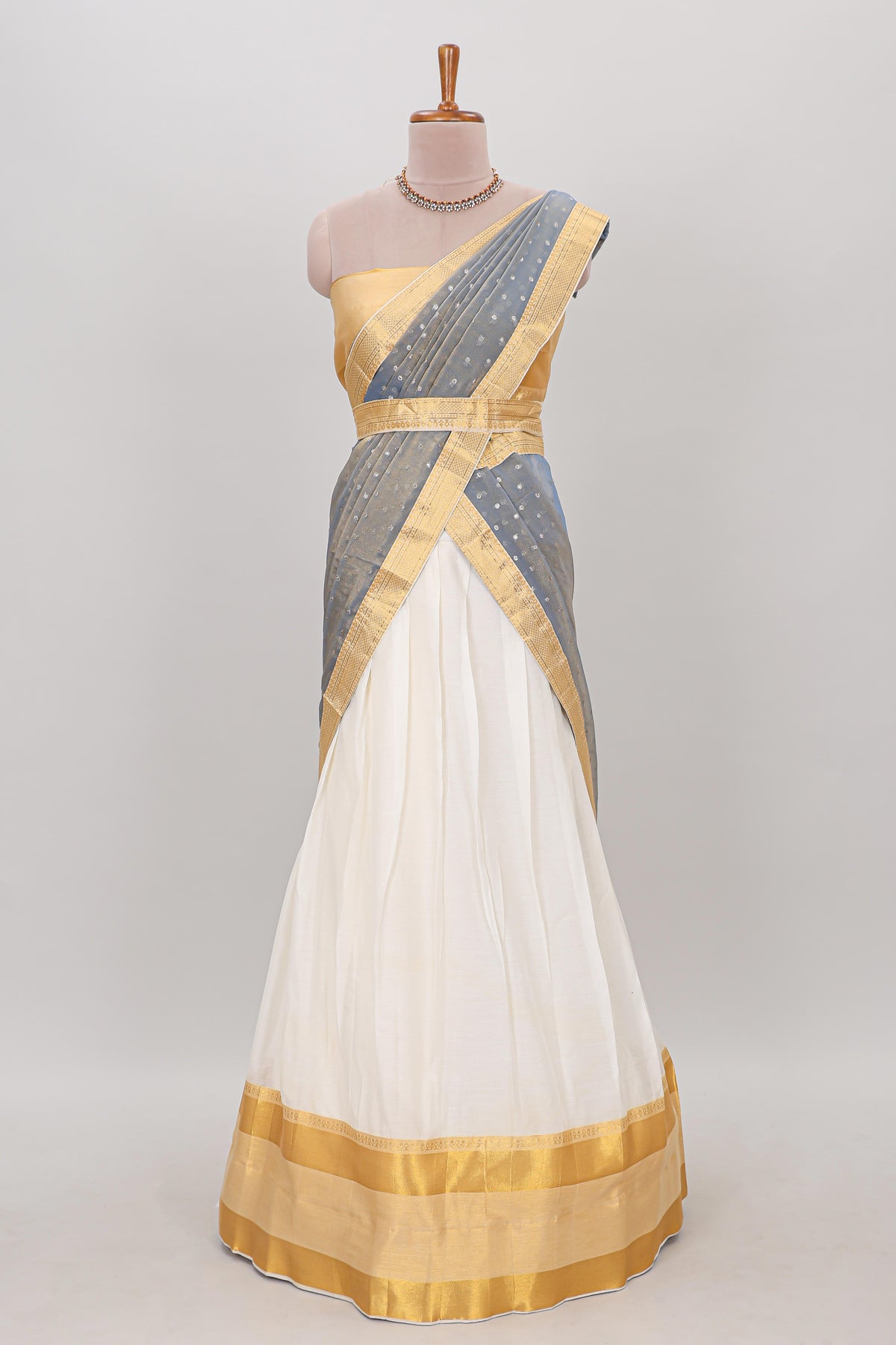 White plain lehanga featuring matching blouse paired with grey stone work dhavani