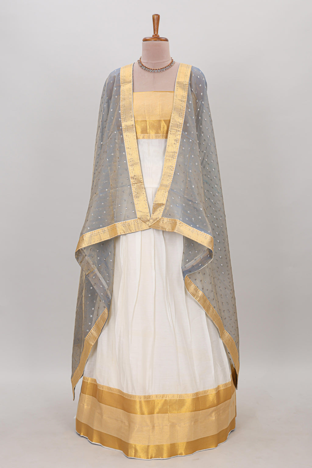 White plain lehanga featuring matching blouse paired with grey stone work dhavani