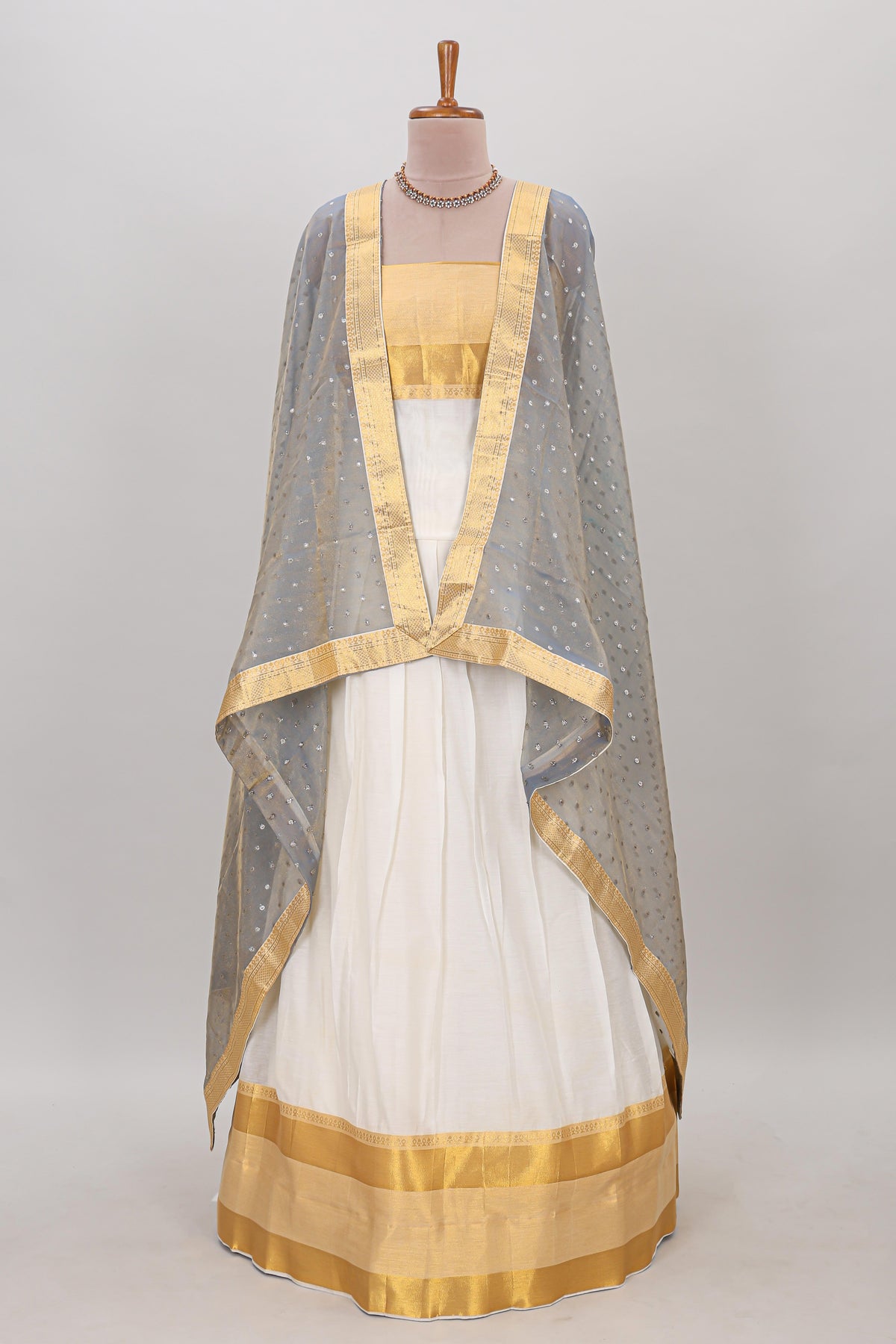 White plain lehanga featuring matching blouse paired with grey stone work dhavani