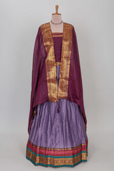 Lavender shade plain lehanga featuring contrasting zari border and blouse paired withmaroonshawl