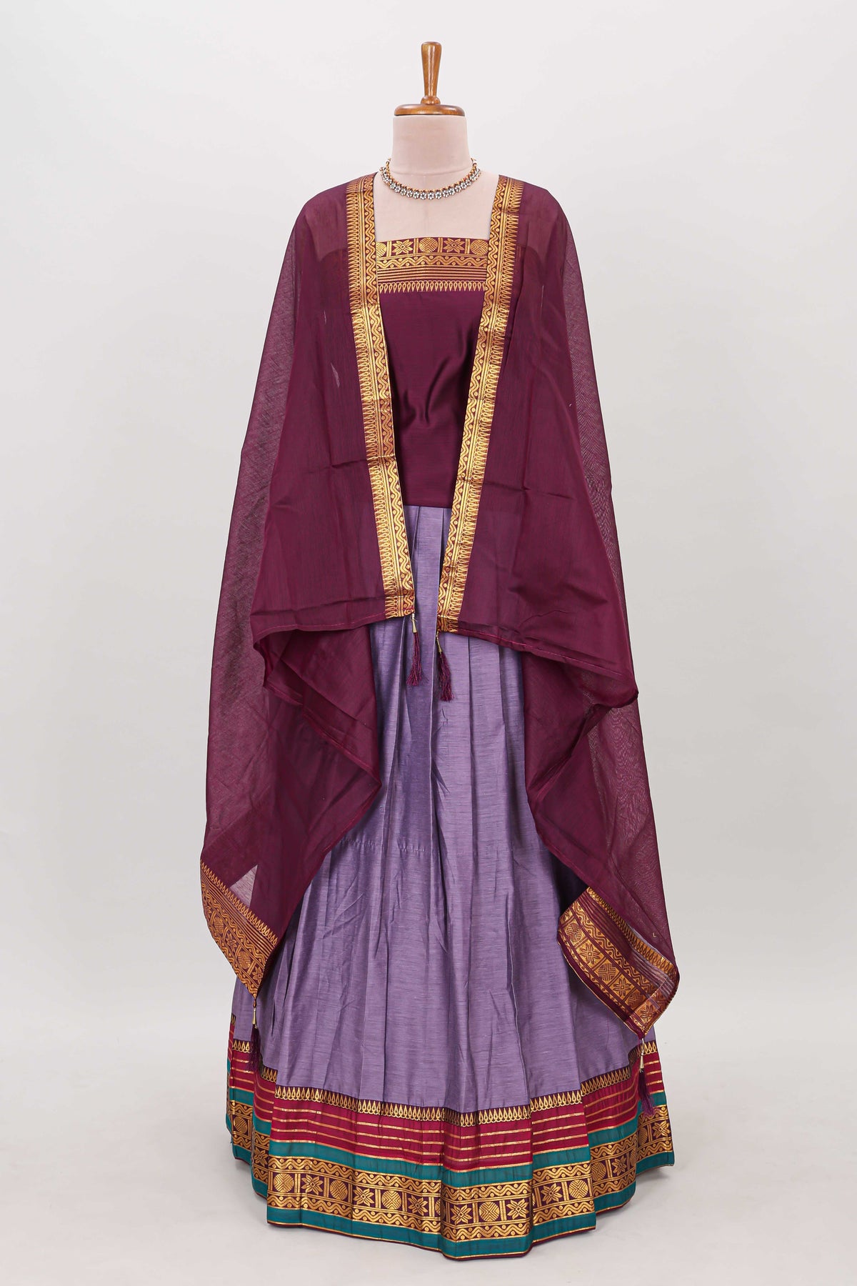 Lavender shade plain lehanga featuring contrasting zari border and blouse paired with  maroon  shawl