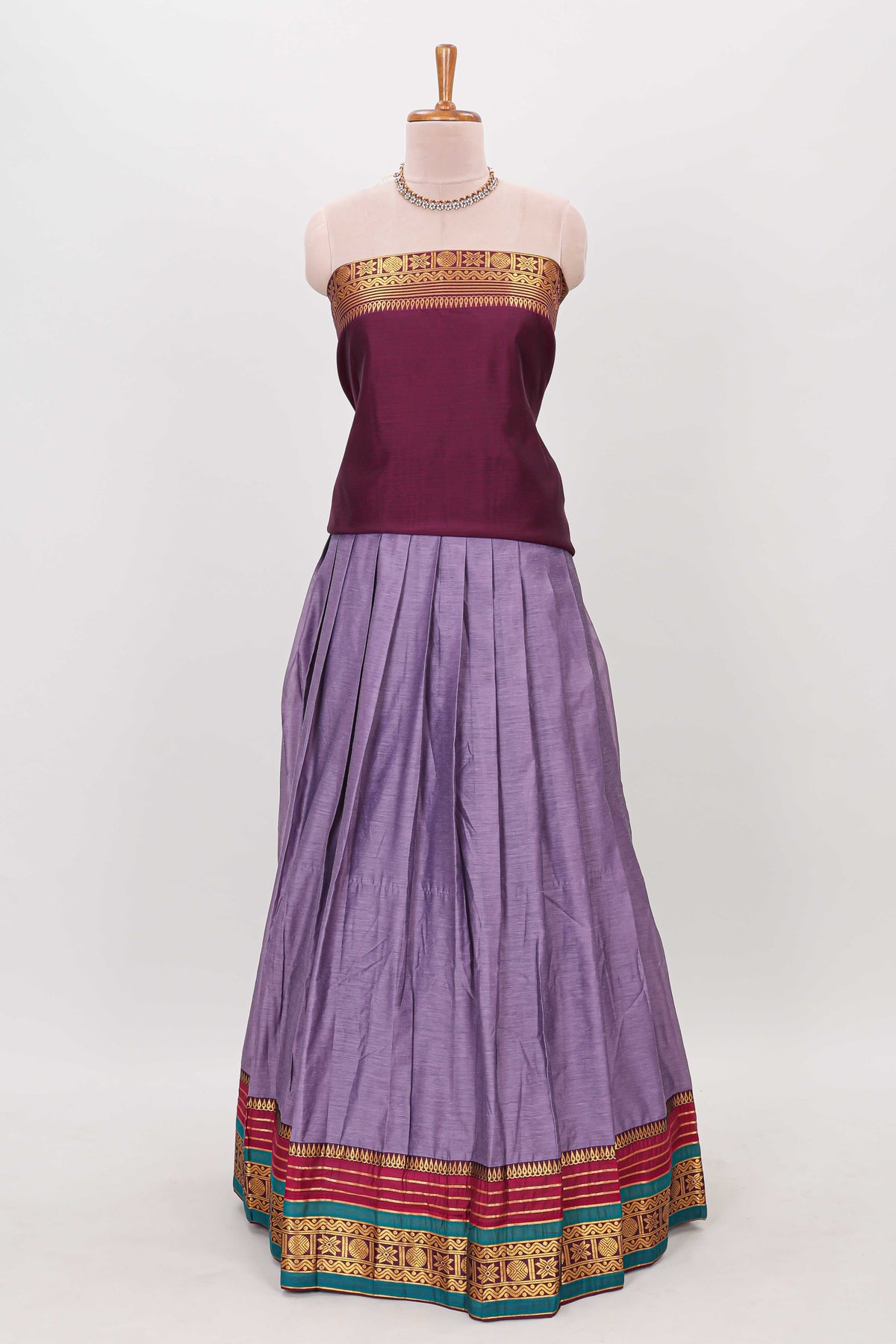 Lavender shade plain lehanga featuring contrasting zari border and blouse paired with  maroon  shawl