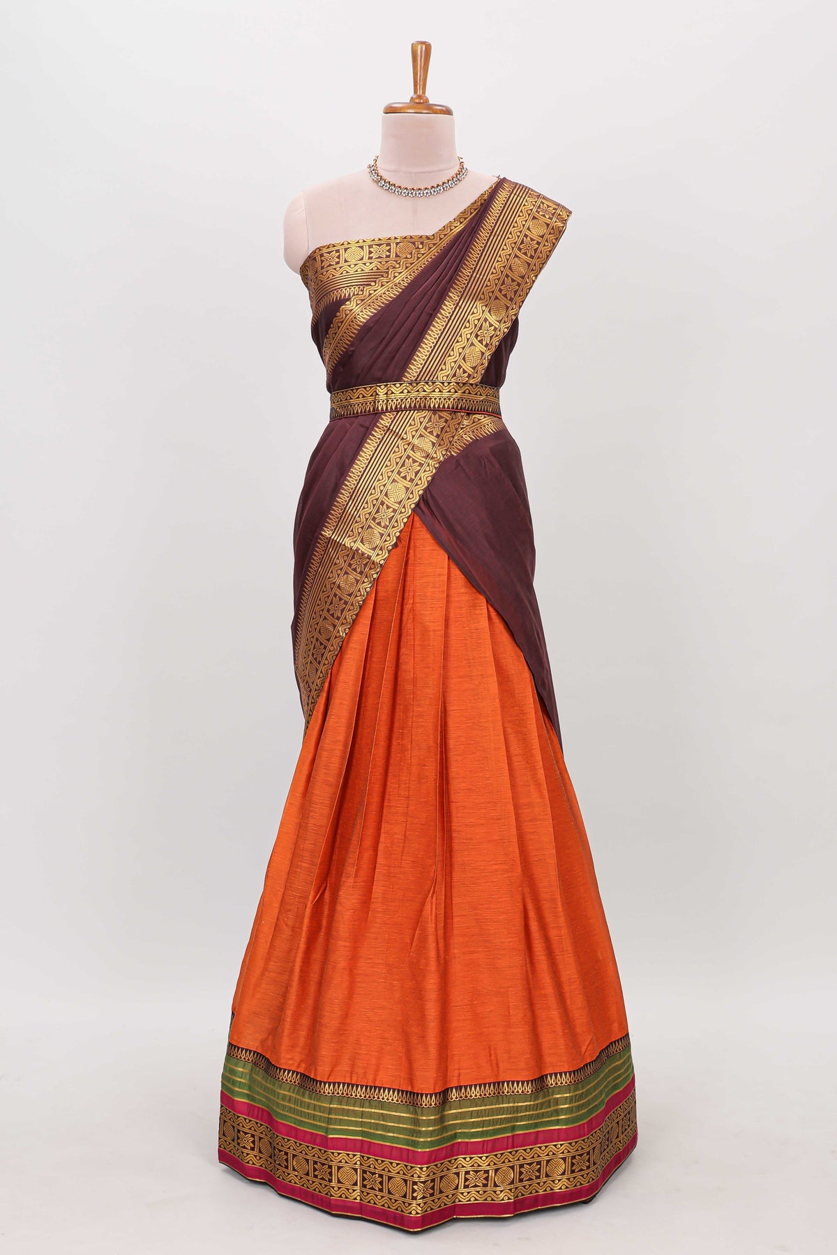 Orange shade plain lehanga featuring contrasting zari border and blouse paired with brown shawl