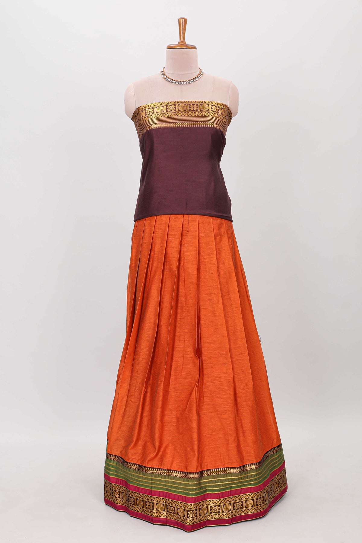 Orange shade plain lehanga featuring contrasting zari border and blouse paired with brown shawl